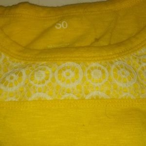 A yellow shirt with showing sholders